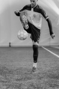 Soccer player in motion, skillfully controlling the ball during practice.